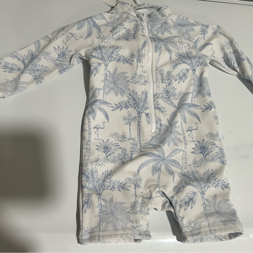 Blue and White tropical Baby Swimsuit with matching bucket hat.